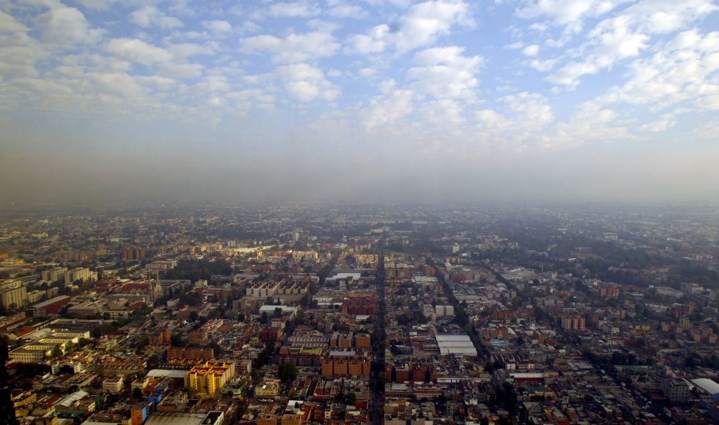 An aerial view of Mexico City taken in 2007. It's morning, but already a layer of smog hovers over the metropolis.