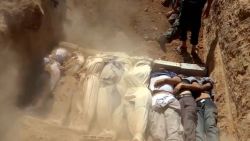 An image grab taken from a video uploaded on YouTube by the Local Committee of Arbeen on August 21, 2013 allegedly shows Syrians covering a mass grave containing bodies of victims that Syrian rebels claim were killed in a toxic gas attack by pro-government forces in eastern Ghouta and Zamalka, on the outskirts of Damascus. The allegation of chemical weapons being used in the heavily-populated areas came on the second day of a mission to Syria by UN inspectors, but the claim, which could not be independently verified, was vehemently denied by the Syrian authorities, who said it was intended to hinder the mission of UN chemical weapons inspectors. AFP PHOTO / YOUTUBE / LOCAL COMMITTEE OF ARBEEN== RESTRICTED TO EDITORIAL USE - MANDATORY CREDIT "AFP PHOTO / YOUTUBE / LOCAL COMMITTEE OF ARBEEN" - NO MARKETING NO ADVERTISING CAMPAIGNS - DISTRIBUTED AS A SERVICE TO CLIENTS - AFP IS USING PICTURES FROM ALTERNATIVE SOURCES AS IT WAS NOT AUTHORISED TO COVER THIS EVENT, THEREFORE IT IS NOT RESPONSIBLE FOR ANY DIGITAL ALTERATIONS TO THE PICTURE'S EDITORIAL CONTENT, DATE AND LOCATION WHICH CANNOT BE INDEPENDENTLY VERIFIED ==        (Photo credit should read DSK/AFP/Getty Images)