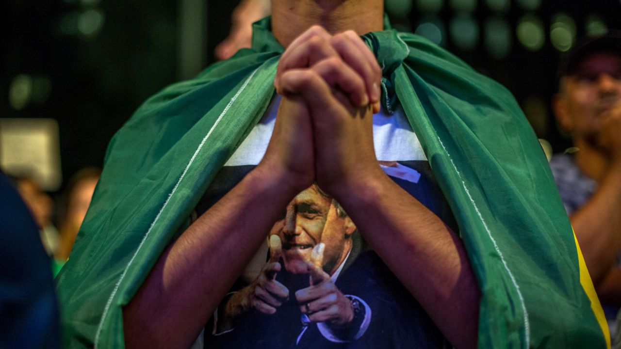 A demonstrator clasps his hands during protests in Sao Paulo on March 17.