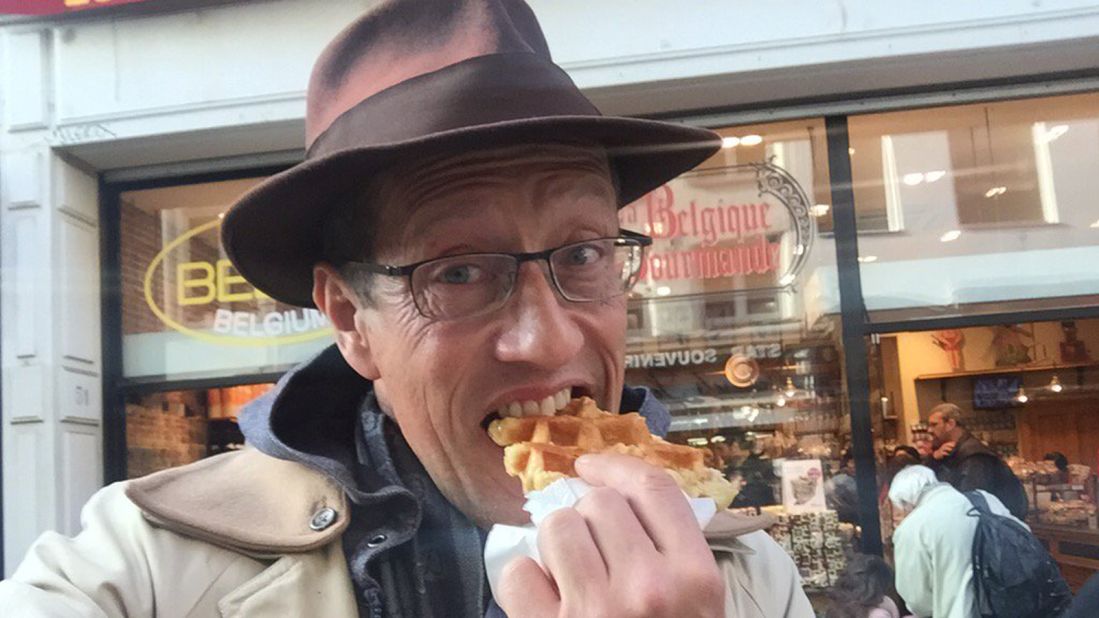Richard Quest asked social media users to set him challenges using the hashtag #flywithquest. Tasked with eating local food, he tucks into a waffle in Brussels. 