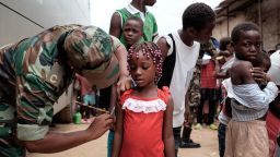 Angolan military administers a yellow fever vaccine to a child at 'Quilometro 30' market, Luanda, Angola on February 16, 2016. This market in the Angolan capital was considered the center of the yellow fever outbreak killing 51 people out of 240 cases since December of 2015.  
