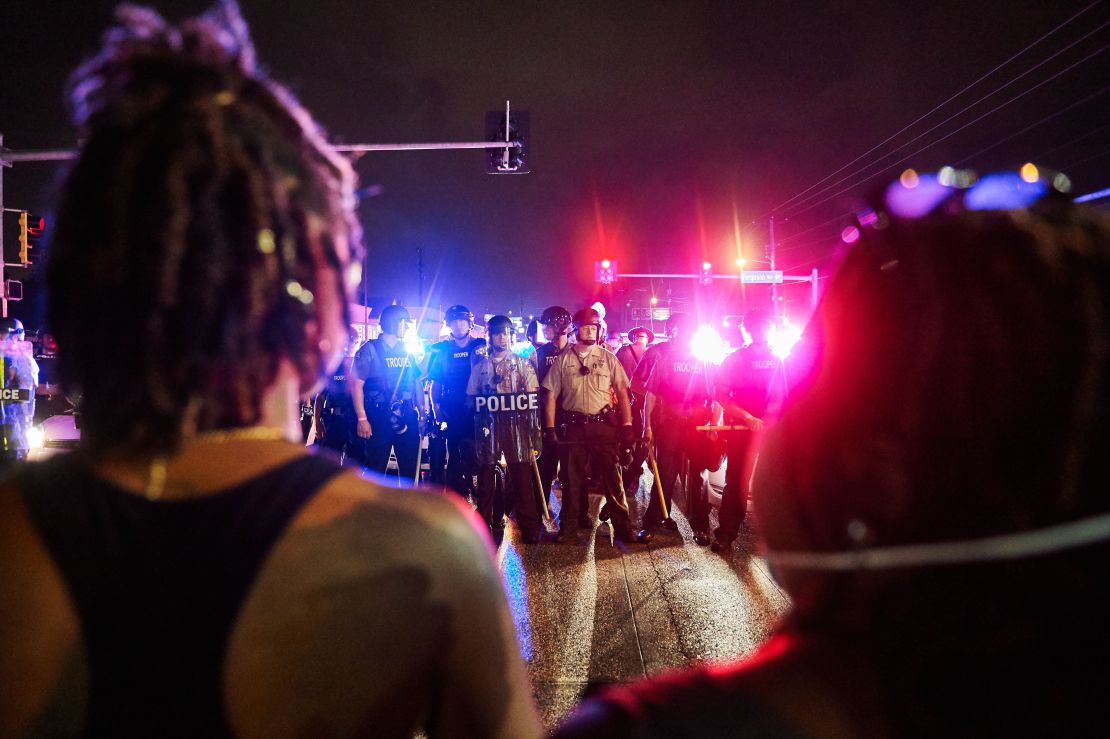 St. Louis County Police and the Missouri State Highway Patrol watch Ferguson marchers.