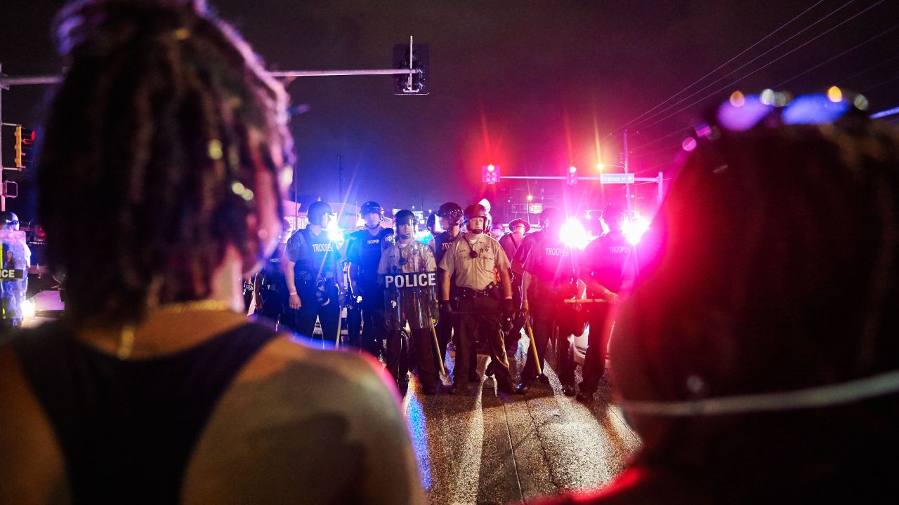 St. Louis County Police and the Missouri State Highway Patrol watch Ferguson marchers.