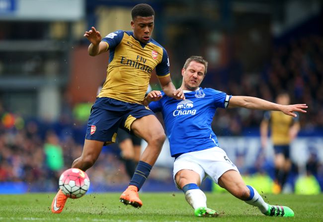 Arsenal's Nigerian 19-year-old winger Alex Iwobi (left) made his first-team debut with a stunning goal against Everton. Here he battles defender Phil Jagielka during the Premier League match at Goodison Park. 