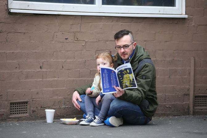 Everton fans, meanwhile, were more subdued. These two spent time reading the matchday program outside Goodison Park stadium prior to the Premier League match between Everton and Arsenal. 