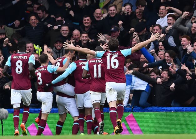 West Ham United players celebrate a goal with away supporters during the English Premier League football match on Saturday at Stamford Bridge. West Ham are battling to finish in the top four for the first time since the establishment of the Premier League in 1992. 
