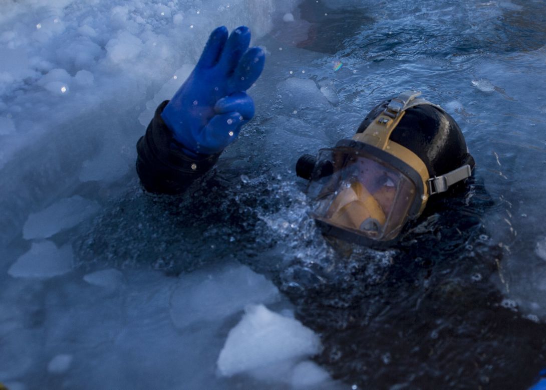 Coast Guard Diver 2nd Class Garett Brada performs an ice dive in the Arctic Circle during ICEX 2016.