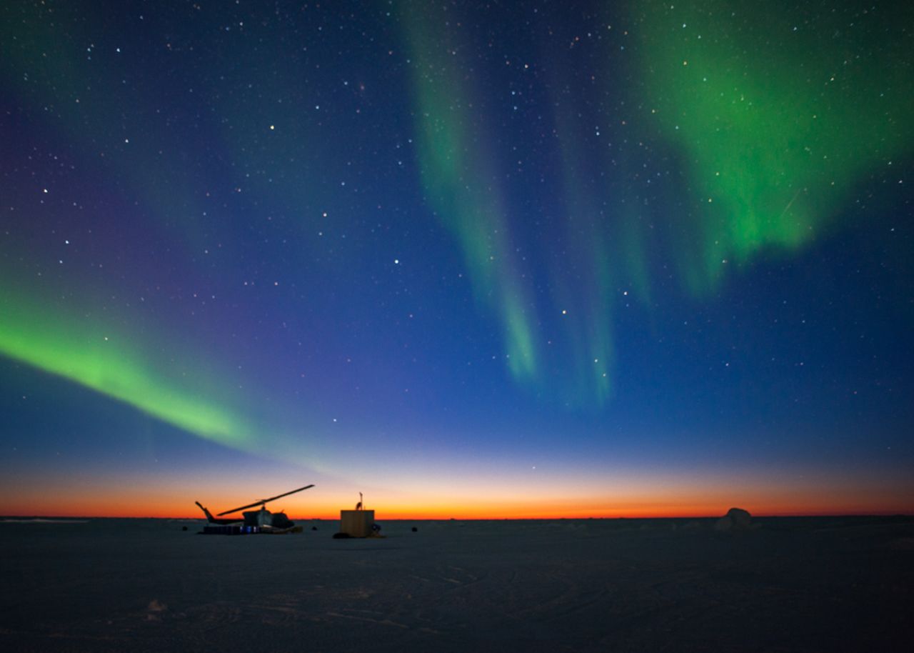The aurora borealis appears over Ice Camp Sargo as the sun sets during ICEX 2016.