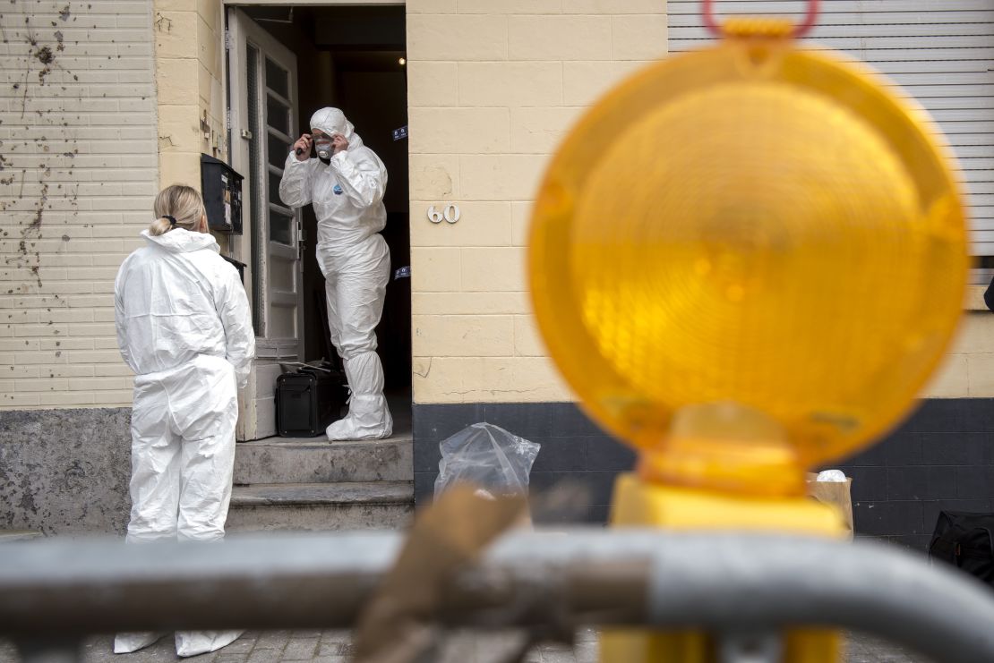 Forensics officers examine a house where Paris attacker Salah Abdeslam is thought to have hidden out