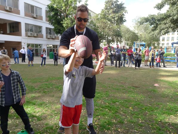 The professional players taught children how to throw and catch a football. For many of the youngsters, it was their first exposure to the sport.
