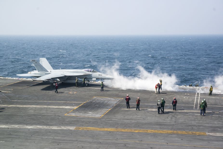 An F/A-18 Super Hornet descends and lands on USS John C. Stennis, Saturday, March 19, 2016. Dozens of fighter jets and other aircraft are on board the carrier. It's leading a strike group of about 8,400 troops for military drills with North Korea.