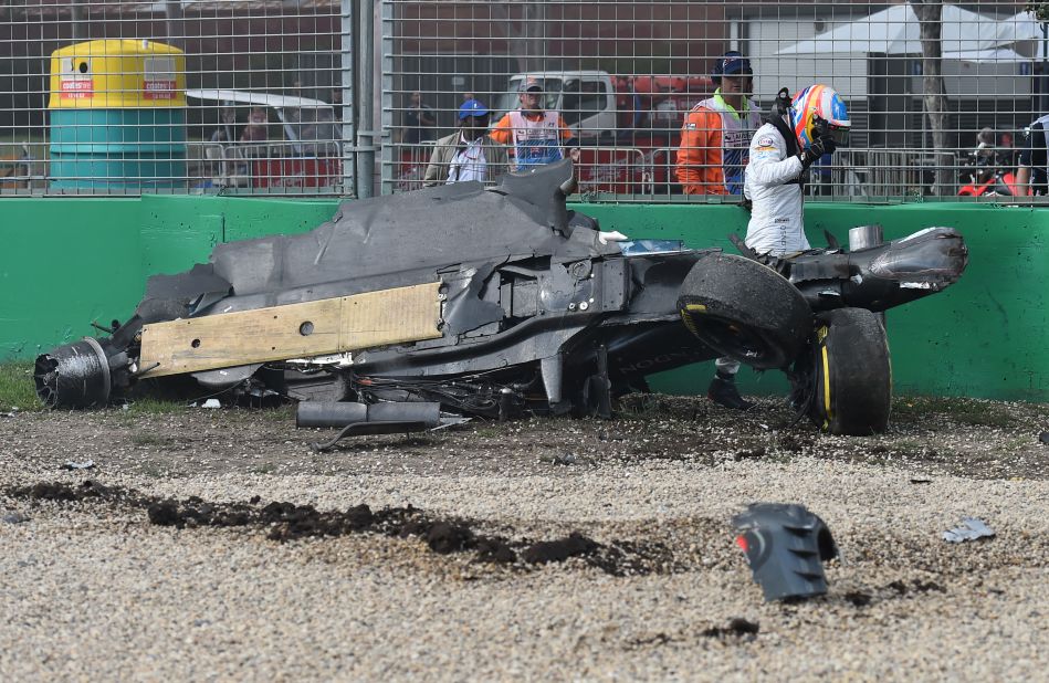 McLaren driver Fernando Alonso walks away from the wreckage of his car after colliding with the Haas of Esteban Gutierrez during the Australian Grand Prix in Melbourne on Sunday.