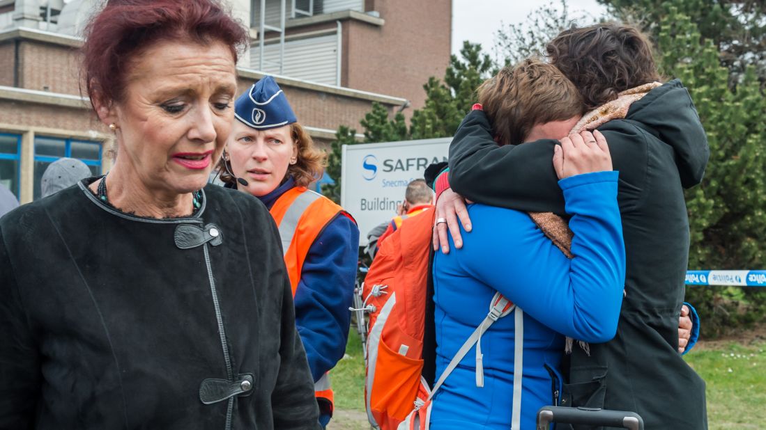 People embrace outside the Brussels airport.