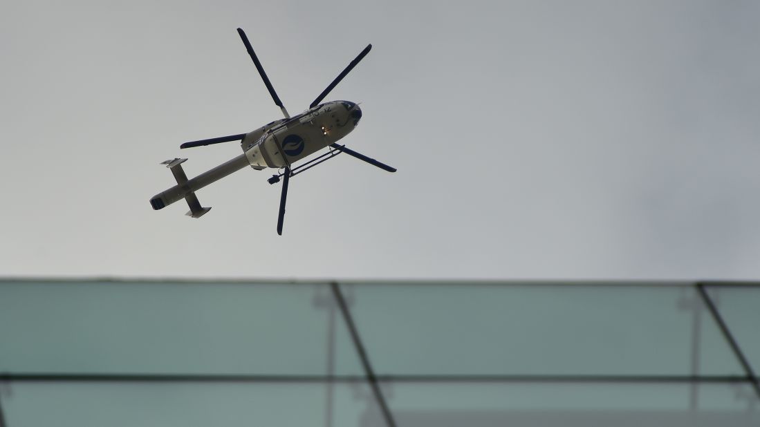 A police helicopter flies above the area near the subway station.