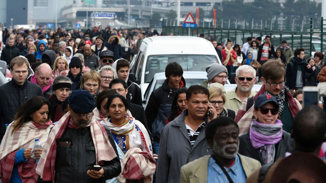 Passengers leave the airport after the attack.