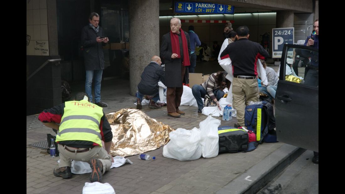 Wounded people are treated outside the subway station.