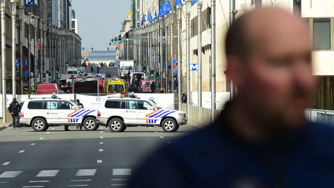 Police officers stand guard near the Maelbeek metro station.