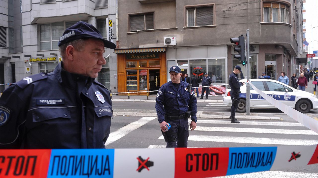 Policemen stand guard near a bakery where a man blew himself up in the center of the Serbian capital Belgrade on March 21, 2016.