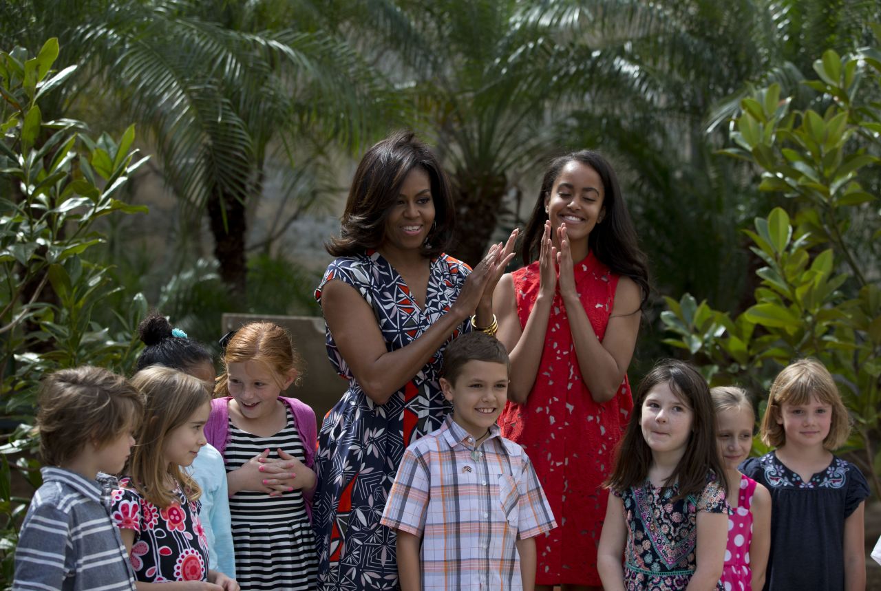 First lady Michelle Obama and her daughter Malia stand with children of U.S. Embassy workers after dedicating a bench and two magnolia trees at a small park in Havana on March 22.