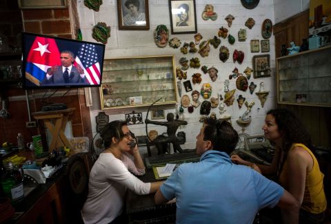 Tourists in a Havana antique shop watch Obama give a speech on March 22.