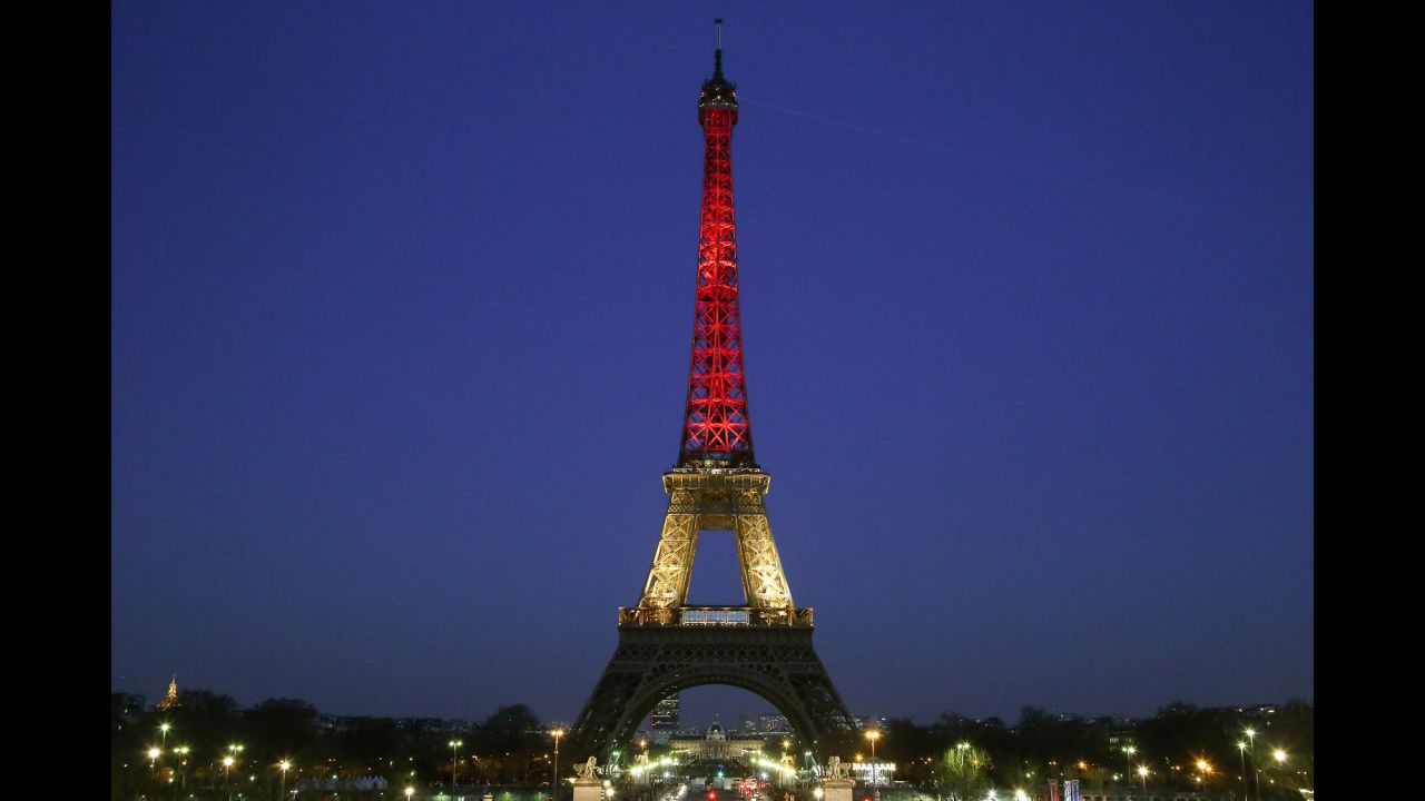 The Eiffel Tower is lit up with the colors of the Belgian flag on March 22.