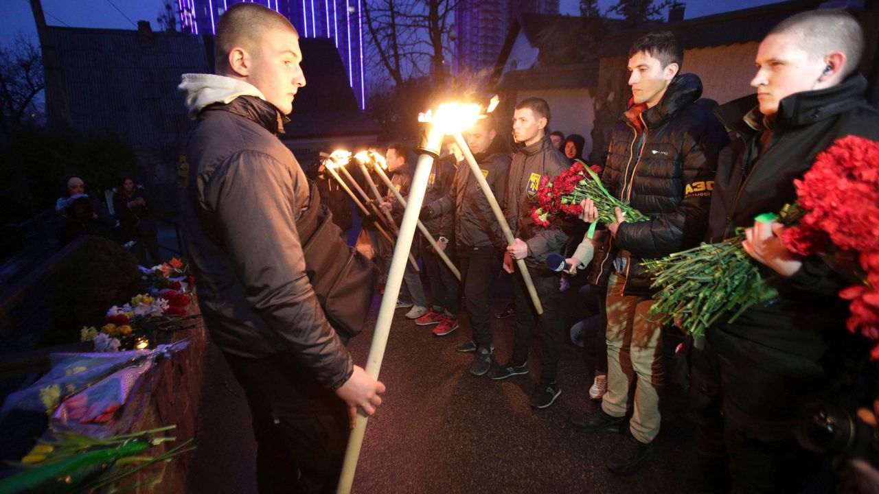 Servicemen with Azov, a Ukrainian volunteer battalion, hold torches during a tribute ceremony at the Belgian Embassy in Kiev, Ukraine, on March 22.