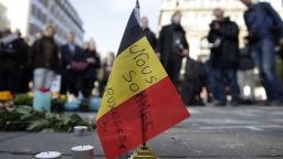 A Belgian flag reading "We are all Brussels" stands at a makeshift memorial at Place de la Bourse (Beursplein) following attacks in Brussels on March 22, 2016. Airlines cancelled hundreds of flights and European railways froze links with Brussels after a series of bomb blasts killed around 35 people in the city's airport and a metro train, sparking a broad security response. AFP PHOTO / KENZO TRIBOUILLARD / AFP / KENZO TRIBOUILLARD        (Photo credit should read KENZO TRIBOUILLARD/AFP/Getty Images)