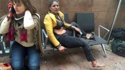 In this photo provided by Georgian Public Broadcaster and photographed by Ketevan Kardava two women wounded in Brussels Airport in Brussels, Belgium, after explosions were heard Tuesday, March 22, 2016. A developing situation left at least one person and possibly more dead in explosions that ripped through the departure hall at Brussels airport Tuesday, police said. All flights were canceled, arriving planes were being diverted and Belgium's terror alert level was raised to maximum, officials said. (Ketevan Kardava/ Georgian Public Broadcaster via AP) 