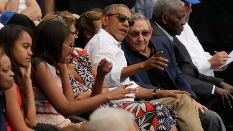US President Barack Obama and Cuban President Raul Castro visit during an exhibition baseball game at the Estado Latinoamericano in March 22, 2016.