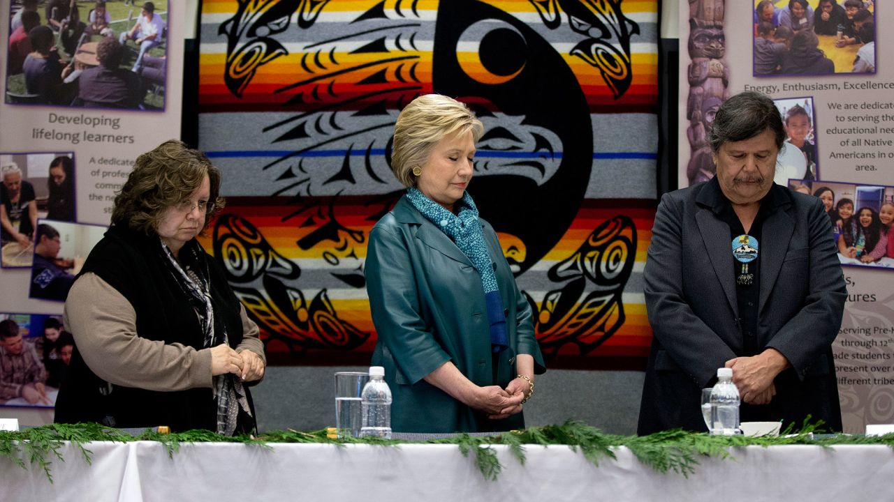 Democratic presidential candidate Hillary Clinton, center, stands for a moment of silence during a roundtable with tribal leaders in Puyallup, Washington, on March 22.