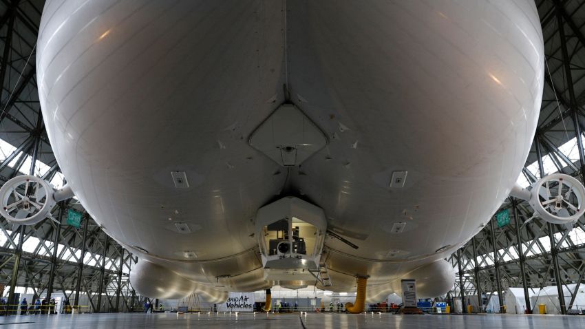 The Airlander 10 airship is pictured airborne in its hangar during its media launch at Cardington Airfield in Shortstown near Bedford on March 21, 2016.
The Airlander, which was originally developed for the US military, is 300 feet (91 metres) long, according its British maker Hybrid Air Vehicles. The Airlander is essentially three streamlined airship-type bodies merged into one with wings and rotary engines. / AFP / ADRIAN DENNIS        (Photo credit should read ADRIAN DENNIS/AFP/Getty Images)