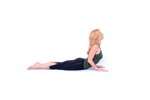 Lying on your stomach, place your hands next to your mid-rib cage with your elbows bent and snug to your sides. Press through your palms as though you're trying to slide your upper body forward through your arms, creating length in your lumbar spine (low back). Inhale as you slowly begin straightening your arms and lifting your shoulders. Exhale and focus on drawing your shoulder blades down toward your waist, feeling your midback muscles engage to create and sustain extension in your spine. Take five long deep breaths. Rest and repeat.