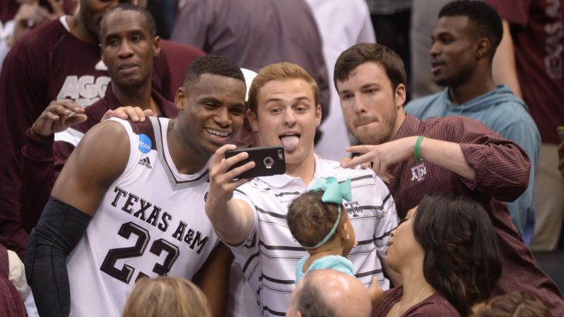 After his team pulled off <a href="index.php?page=&url=http%3A%2F%2Fbleacherreport.com%2Farticles%2F2626376-texas-am-goes-on-14-2-run-in-31-seconds-to-send-game-to-ot-vs-northern-iowa" target="_blank" target="_blank">one of the greatest comebacks in college basketball history,</a> Texas A&M guard Danuel House celebrates with fans in Oklahoma City on Sunday, March 20. The Aggies trailed Northern Iowa by 12 points with less than a minute to play in regulation, but they rallied to win in double overtime.