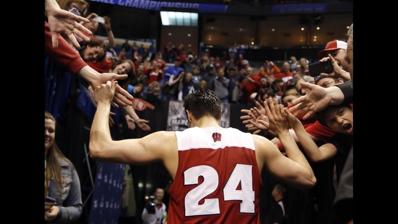 Wisconsin's Bronson Koenig is congratulated by fans following a second-round win on Sunday, March 20. Koenig <a href="index.php?page=&url=http%3A%2F%2Fbleacherreport.com%2Farticles%2F2626377-wisconsin-g-bronson-koenig-buries-3-pointer-at-the-buzzer-to-beat-xavier" target="_blank" target="_blank">hit a 3-pointer at the buzzer</a> to upset Xavier.