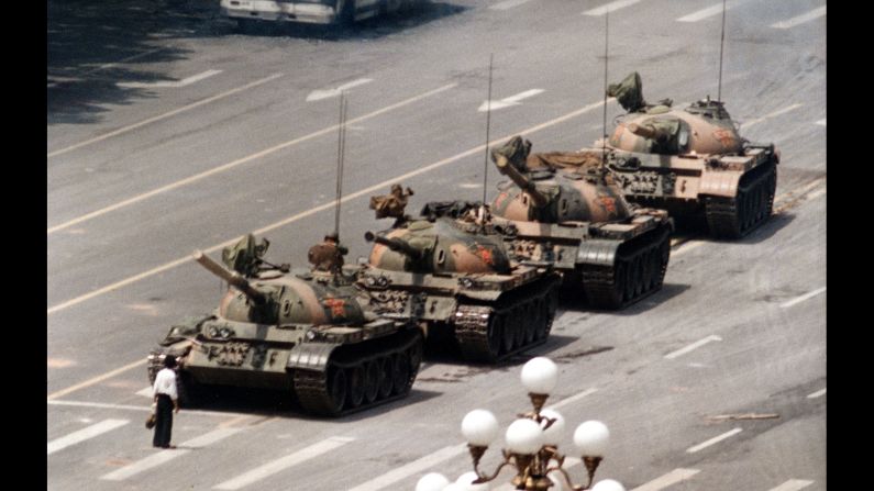 <strong>Tiananmen massacre: </strong>In this iconic photo from Beijing's Tiananmen Square, an unidentified man stands alone on Cangan Boulevard, blocking the advance of military tanks on June 5, 1989. Anywhere from hundreds to thousands of people died the day before when Chinese <a href="index.php?page=&url=http%3A%2F%2Fwww.cnn.com%2F2013%2F09%2F15%2Fworld%2Fasia%2Ftiananmen-square-fast-facts%2F" target="_blank">troops fired on civilians</a> who were participating in peaceful anti-government protests in the square. The demonstrations, initiated by students seeking democratic reform and an end to government corruption, also led to thousands of arrests and several dozen executions. Tiananmen, ironically, means "Gate of Heavenly Peace."