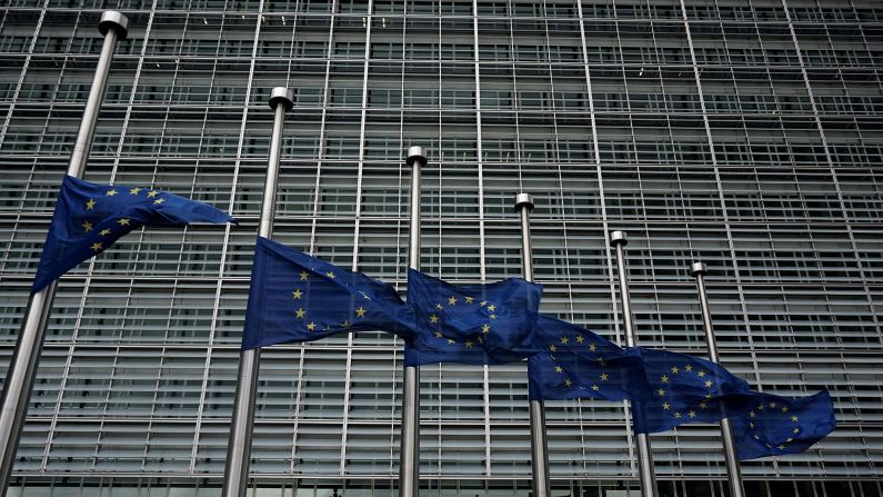 European Union flags fly at half-staff outside the European Commission in Brussels on March 23.