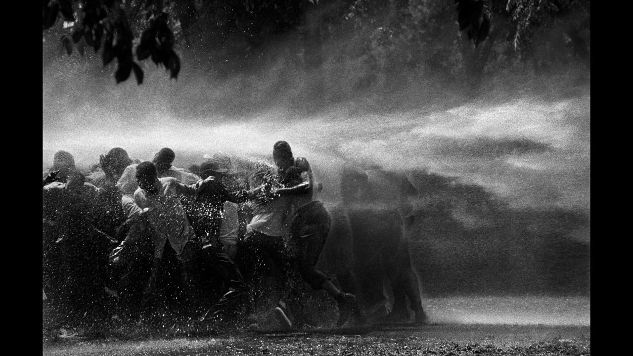 Civil rights demonstrators are sprayed with water in Birmingham, Alabama, in 1963. "I have never witnessed such cruelty," Adelman said. "There was almost as much moisture behind the lens as in front. I gave a print of this picture to Dr. King. He studied it and said, 'I am startled that out of so much pain some beauty came.' "