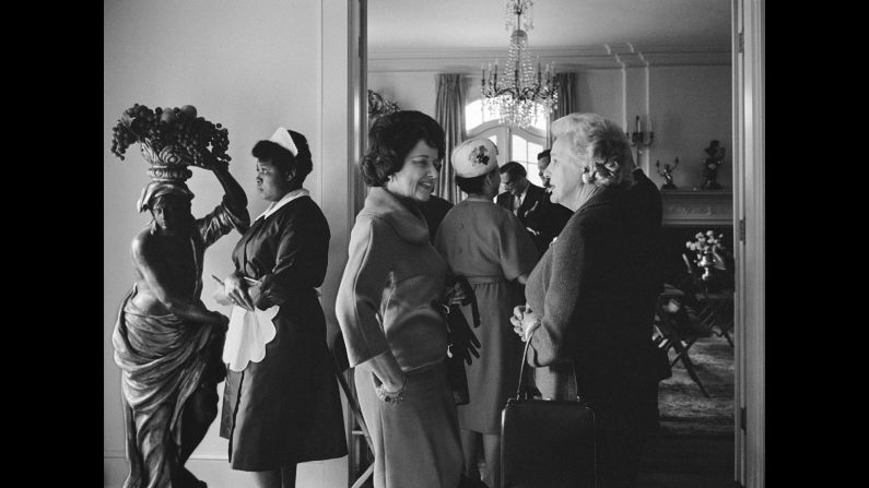 White women socialize near a black maid at a party in Dallas in 1965.