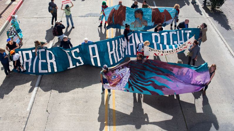 Climate activists marched on the Superdome carrying signs that said "Keep it in the ground" and "Solar doesn't spill." Louisiana has been hit hard by environmental disasters, from Hurricane Katrina to the BP oil spill.