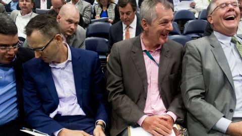 Bidders from the oil and gas industry laugh about a climate change protest at a federal fossil fuel lease auction held Wedneday at the Superdome in New Orleans.