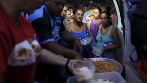 Cuban migrants queue for donated food at a provisional shelter in Paso Canoas, Panama, on March 20.