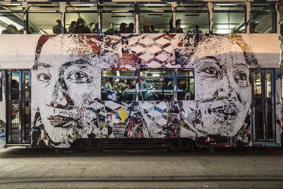 Vhils plastered a moving tram, a century-old form of transport in Hong Kong, with his signature work. The portraits on the facade are based on anonymous residents of the city. 