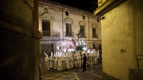 Penitents carry an image of Jesus Christ through the streets in Caravaca de la Cruz, Spain, on Thursday, March 24.