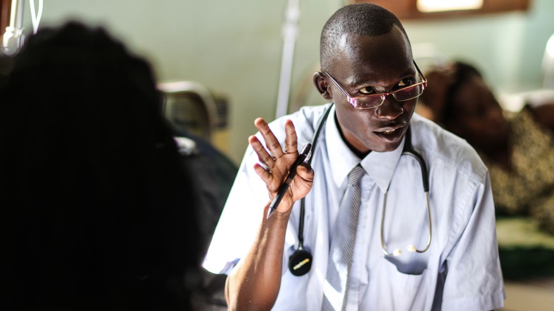 Dr. Dan consults with a patient at the Masindi Kitara Medical Center before an exam.
