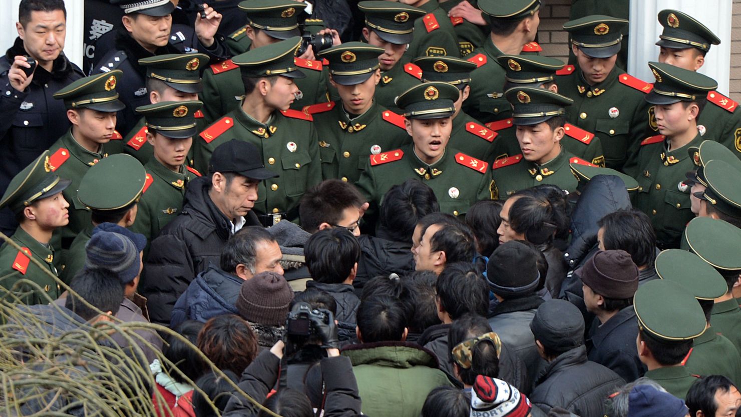 Migrant workers confront Chinese paramilitary police in Beijing over a pay dispute. Strikes and worker protests are on the rise across China. 