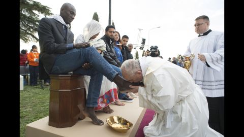 Pope Francis kisses a man's foot at a refugee center outside of Rome on Thursday, March 24. The Pope washed and kissed the feet of Muslim, Orthodox, Hindu and Catholic refugees, declaring them children of the same God. Christians around the world are observing Holy Week, which marks the last week of Lent and the beginning of Easter celebrations.
