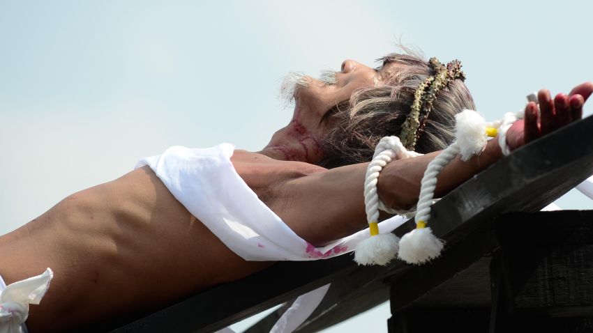SAN FERNANDO, PAMPANGA - MARCH 25:  Participants hammer nails to the hand of Filipino Willy Salvador, 59 during a reenactment of Christ's suffering when he was nailed to the cross on Good Friday on March 25, 2016 in San Fernando town in Pampanga province, Philippines. The annual crucifixion and flagellation rites draws huge crowds of people to normally sleepy towns in northern Philippines.  (Photo by Dondi Tawatao/Getty Images)