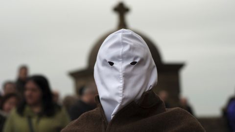A masked penitent from La Santa Vera Cruz brotherhood takes part in an Easter procession known as "Los Picaos" in the small village of San Vicente de La Sonsierra in northern Spain on March 25.