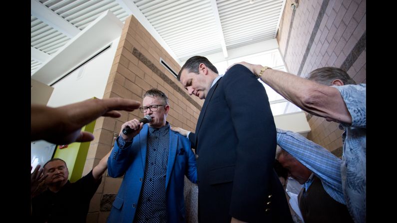 Paul Owens, left, leads a prayer over Republican presidential candidate Ted Cruz at Fresh Start Church in Peoria, Arizona on Sunday, March 20. 