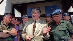 PALE, BOSNIA AND HERZEGOVINA:  Radovan Karadzic (C), Bosnian Serb warlord and leader of the Serb-run part of Bosnia during the 1992-1995 war, addresses media 05 August 1993 in his stronghold of Pale, while Ratko Mladic (L), his military commander, and UN High Commander for Bosnia, Belgian General Francis Briquemont (R) look on. Karadzic and Mladic, both at large, are indicted by the International Criminal Tribunal for the former Yugoslavia (ICTY) in The Hague for war crimes and genocide committed during Bosnia's war. AFP PHOTO (Photo credit should read Michael Evstafiev/AFP/Getty Images)